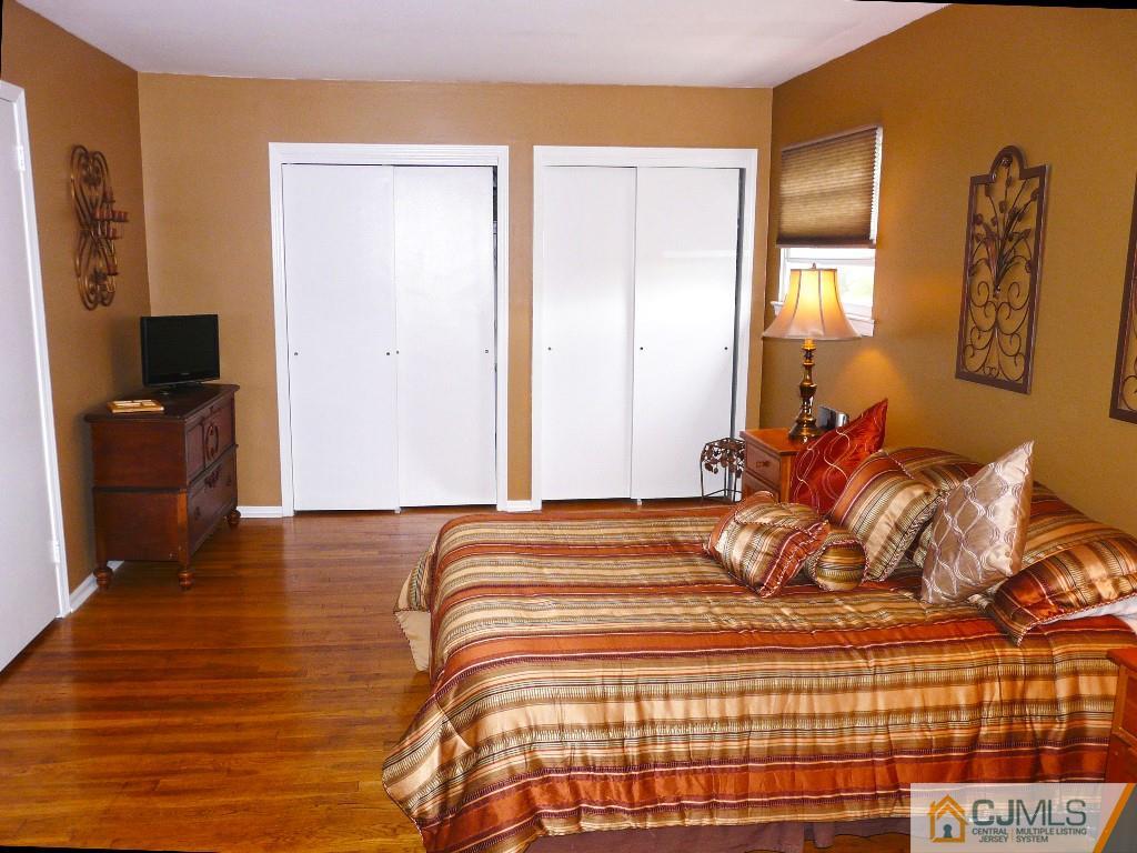 90 Drake Road Somerset, NJ 08873 - Photo 12 of 20 a bedroom with a bed and wooden floor