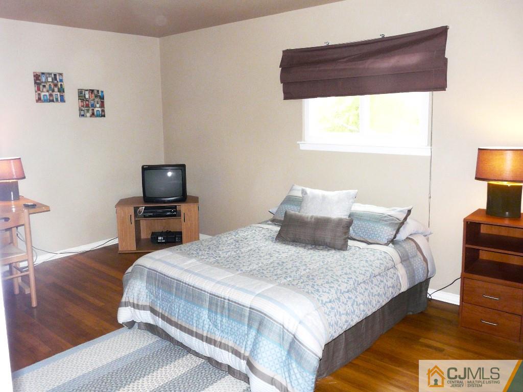 90 Drake Road Somerset, NJ 08873 - Photo 14 of 20 a bedroom with a bed and a night stand