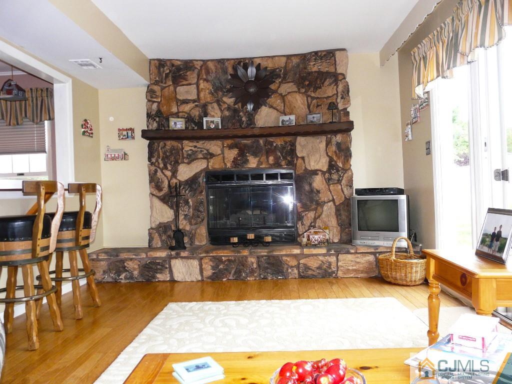 90 Drake Road Somerset, NJ 08873 - Photo 10 of 20 a living room with fireplace furniture and a flat screen tv