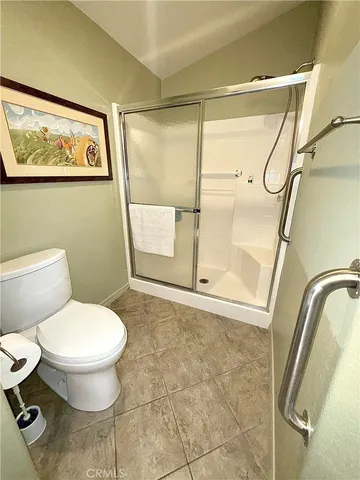 a bathroom with a toilet and a shower