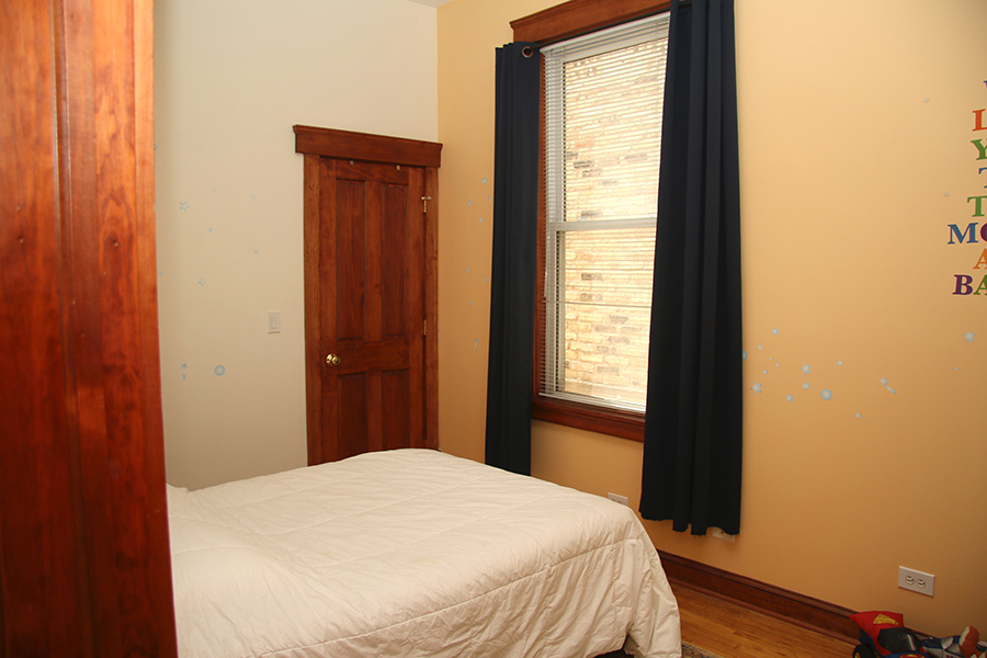 857 West Newport Avenue, Unit 3 Chicago, IL 60657 - Photo 13 of 19 a bedroom with a bed and a window