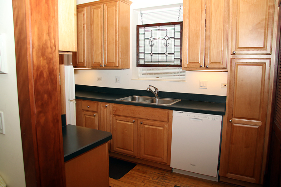857 West Newport Avenue, Unit 3 Chicago, IL 60657 - Photo 7 of 19 a kitchen with granite countertop stainless steel appliances a refrigerator and a sink
