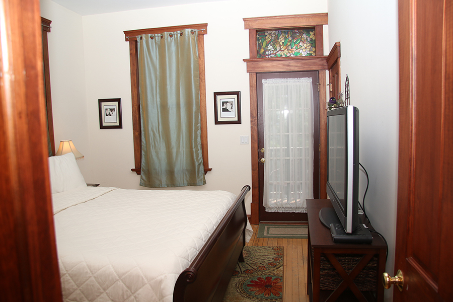 857 West Newport Avenue, Unit 3 Chicago, IL 60657 - Photo 10 of 19 a bedroom with a bed and a mirror