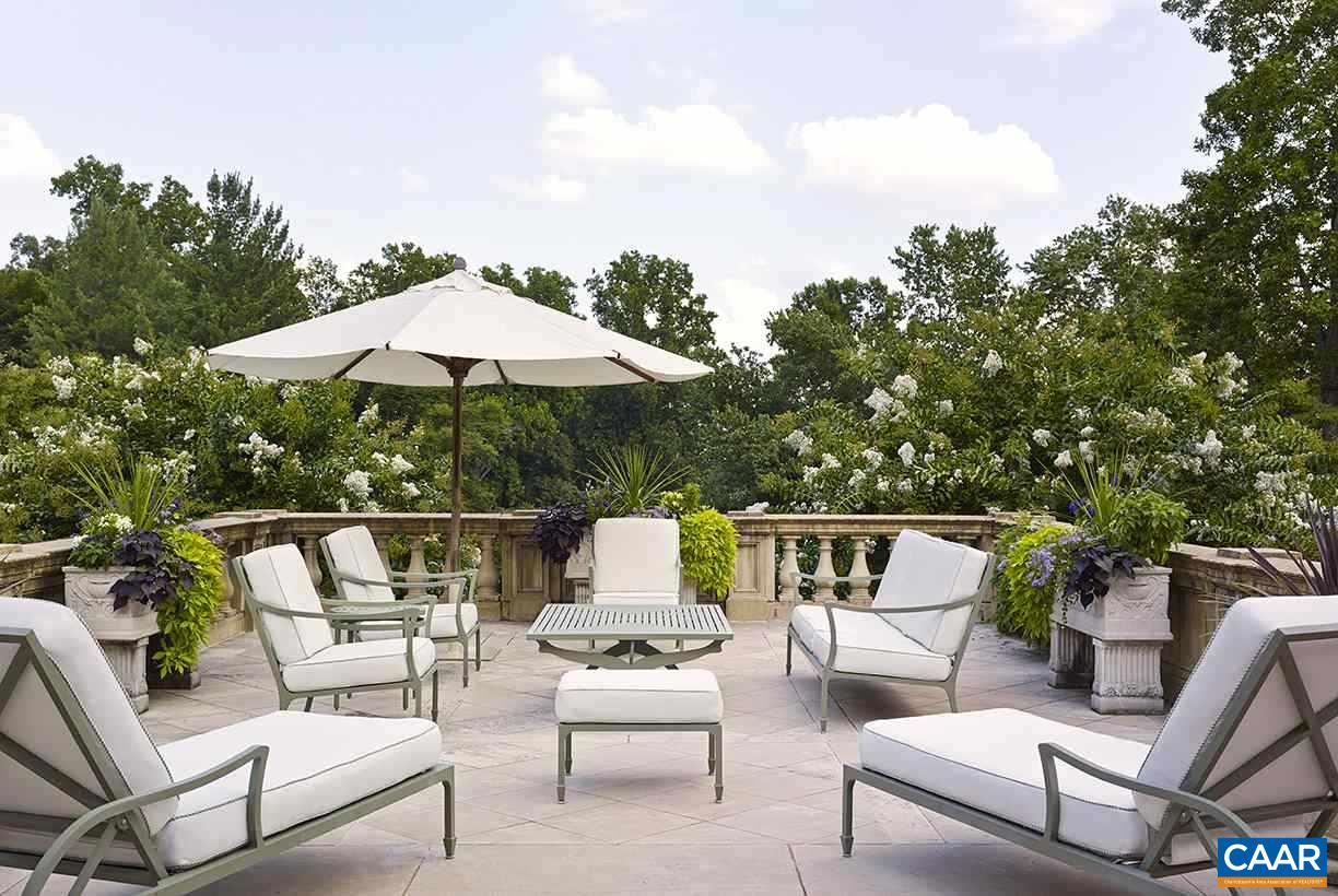 1314 Rugby Road Charlottesville, VA 22903 - Photo 39 of 50 a patio with patio a table and chairs under an umbrella