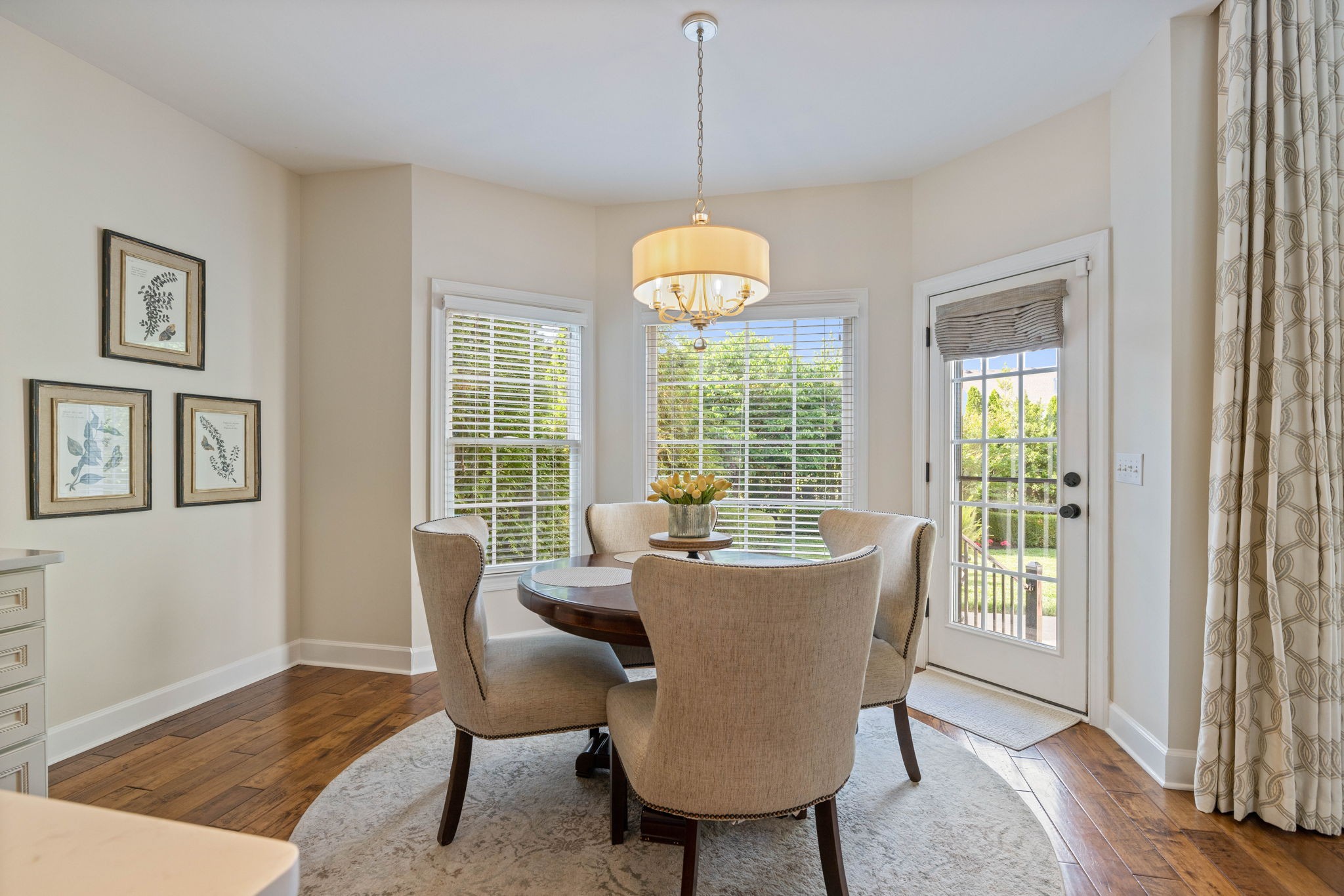 153 Cornerstone Circle Franklin, TN 37064 - Photo 26 of 70 a dining room with furniture a chandelier and wooden floor