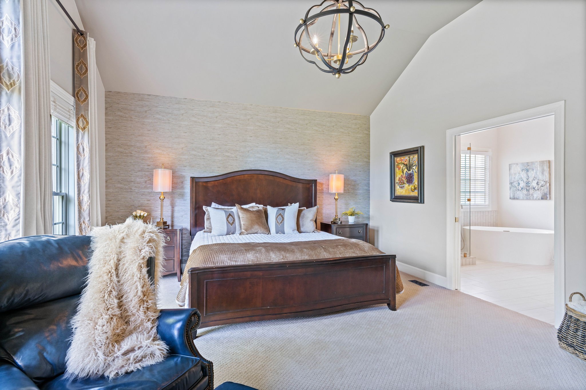 153 Cornerstone Circle Franklin, TN 37064 - Photo 33 of 70 a bedroom with a large bed and a chandelier