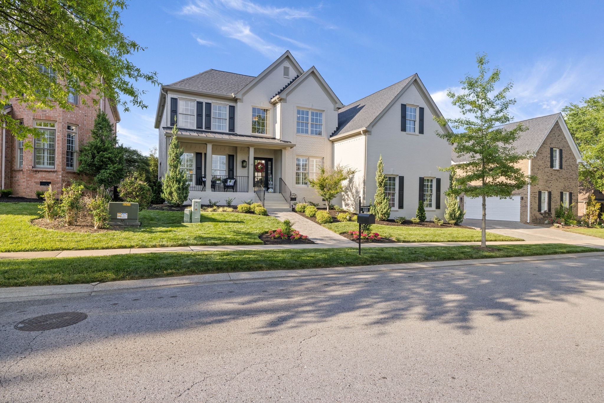 153 Cornerstone Circle Franklin, TN 37064 - Photo 4 of 70 a front view of a house with a yard table and chairs