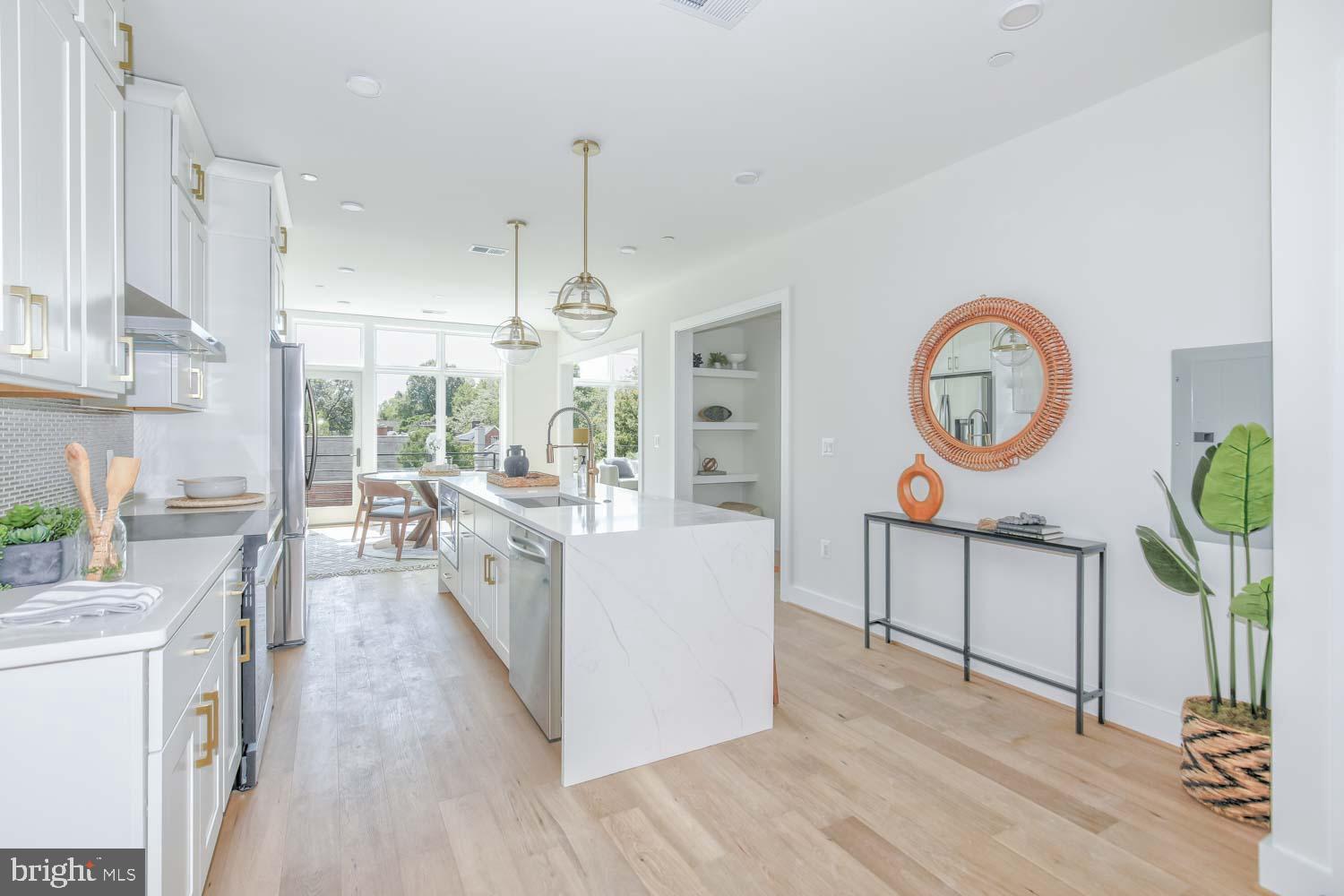 4347 Harrison Street Northwest, Unit 7 Washington, DC 20015 - Photo 4 of 28 a large kitchen with stainless steel appliances a lot of counter space and a wooden floors