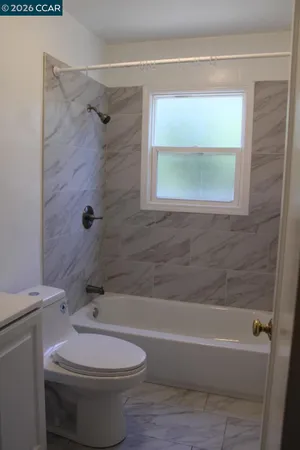a bathroom with a sink a toilet and bathtub