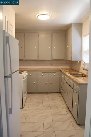 a kitchen with stainless steel appliances cabinets a sink and a refrigerator