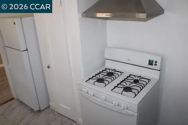 a close view of a stove top oven with wooden floor