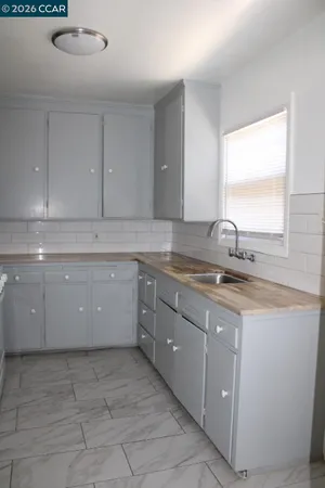 a kitchen with a sink and cabinets