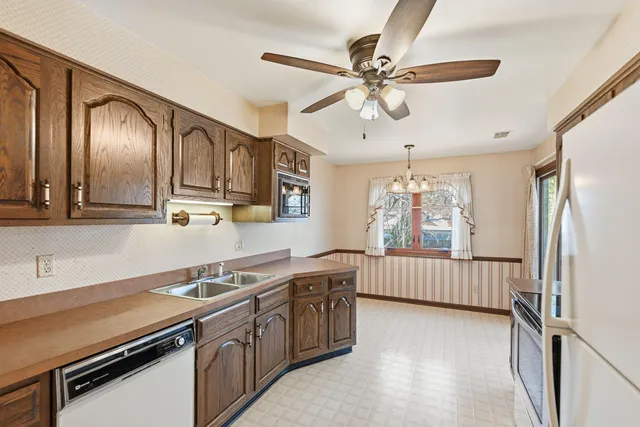 a kitchen with a sink appliances and cabinets