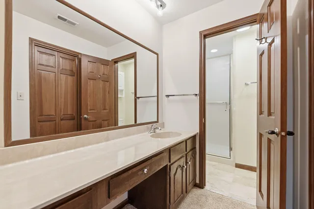 a view of a bathroom with a sink and a mirror