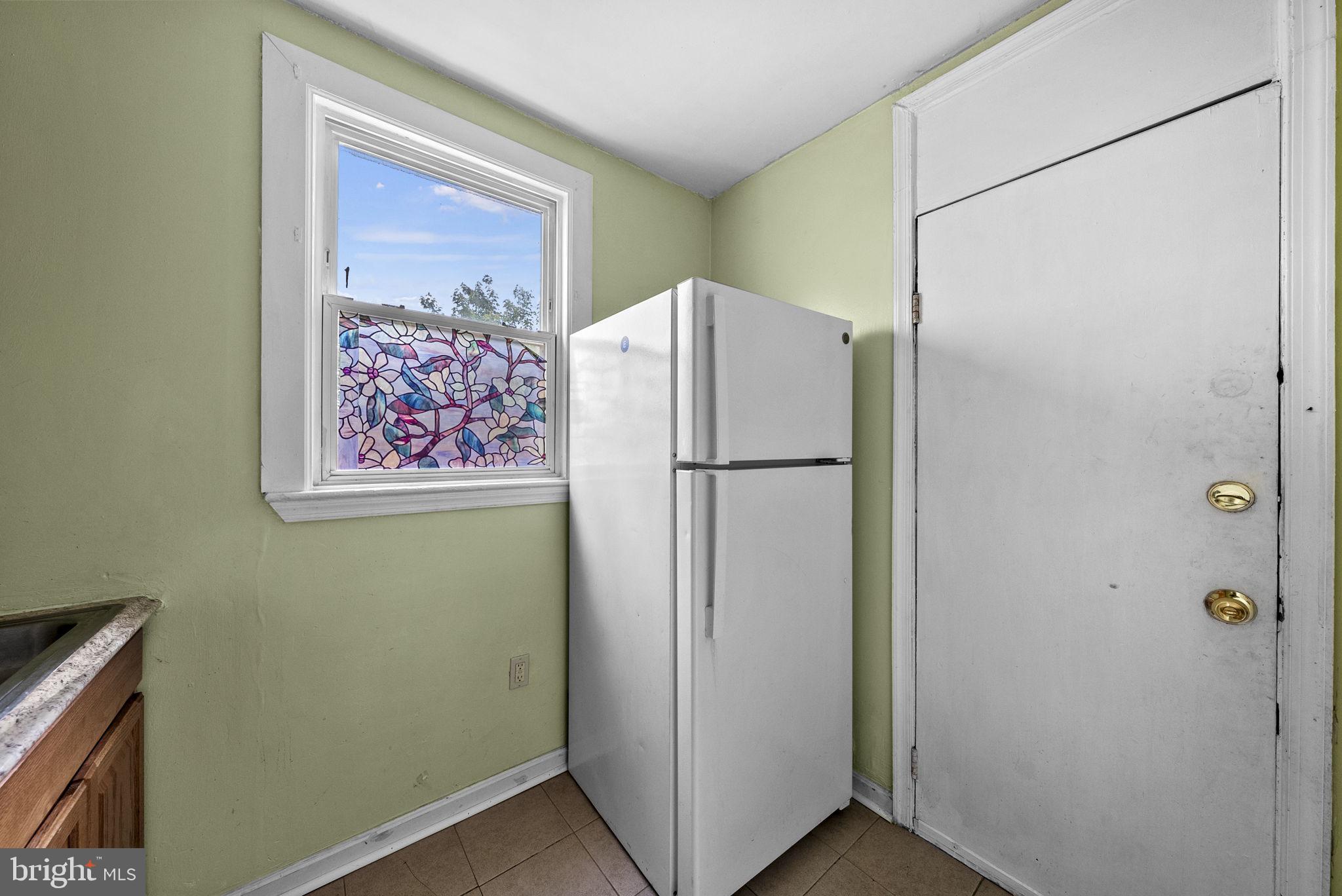 1942 Capitol Avenue Northeast Washington, DC 20002 - Photo 12 of 24 a white refrigerator freezer sitting in a room