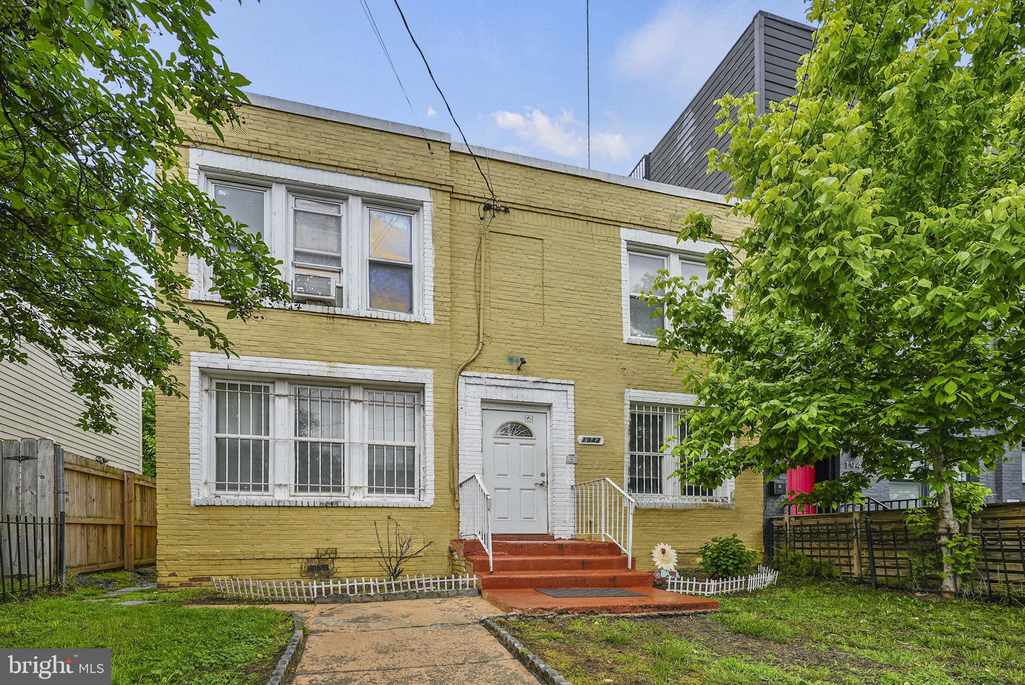 1942 Capitol Avenue Northeast Washington, DC 20002 - Photo 2 of 24 a front view of a house with a yard