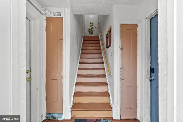 a view of a hallway with wooden floor and entryway