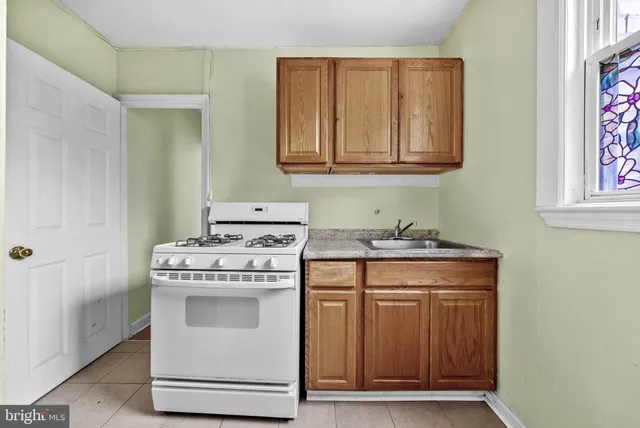 a kitchen with a refrigerator and a stove top oven