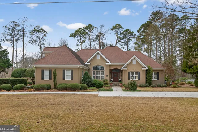 a front view of a house with a garden