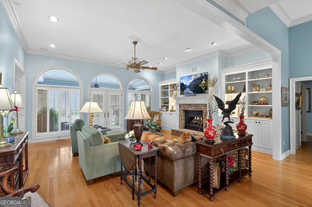 a living room with fireplace furniture and a wooden floor