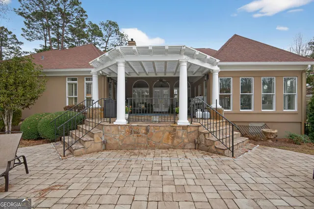 an aerial view of a house with yard and seating space