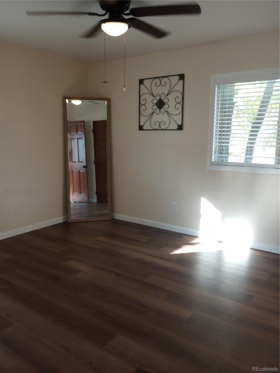 111 Crystal Park Road, Unit 1 Manitou Springs, CO 80829 - Photo 11 of 28 a view of an empty room with wooden floor and a window