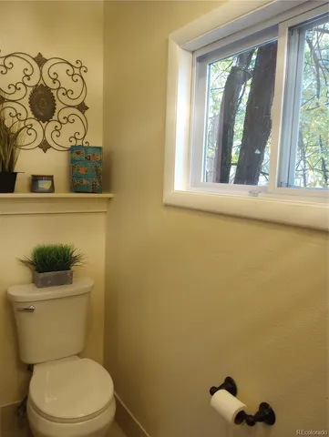 a white toilet sitting next to a window