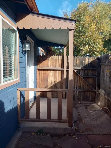 a view of wooden house with a wooden fence