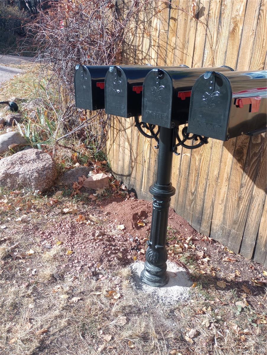 111 Crystal Park Road, Unit 1 Manitou Springs, CO 80829 - Photo 28 of 28 a front view of a house with yard covered in snow