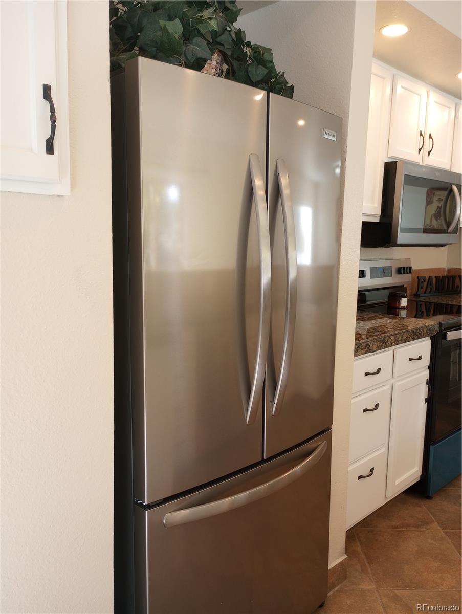111 Crystal Park Road, Unit 1 Manitou Springs, CO 80829 - Photo 7 of 28 a metallic refrigerator freezer sitting in a kitchen