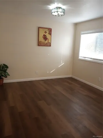 a view of a room with wooden floor and window