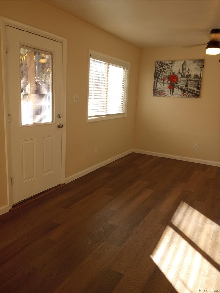 111 Crystal Park Road, Unit 1 Manitou Springs, CO 80829 - Photo 10 of 28 an empty room with wooden floor and windows