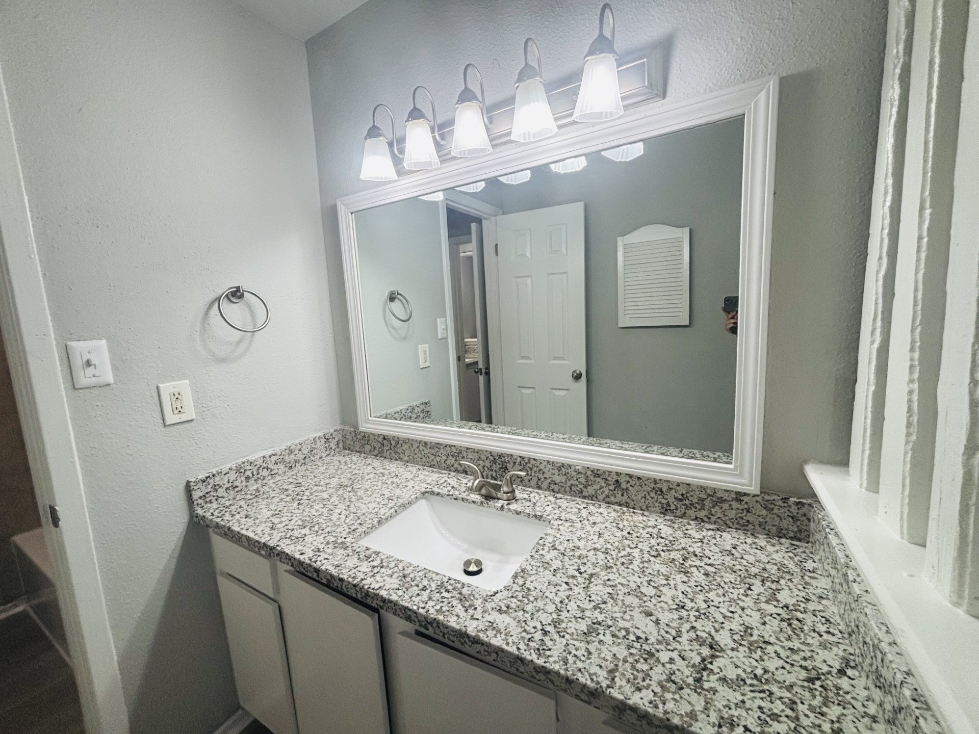 6200 West Tidwell Road, Unit 1109 Houston, TX 77092 - Photo 14 of 18 a bathroom with a granite countertop sink and a mirror