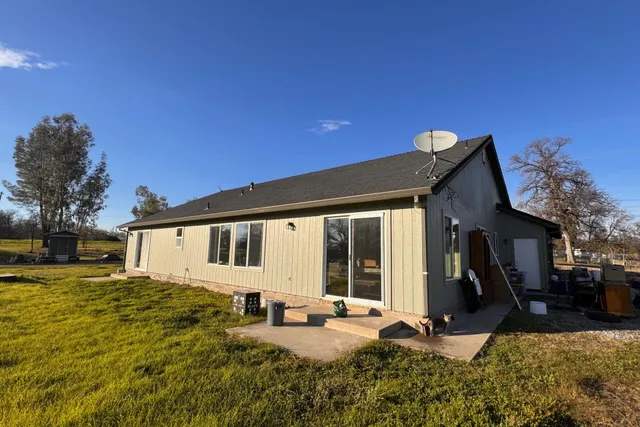 a view of a house with backyard porch and sitting area