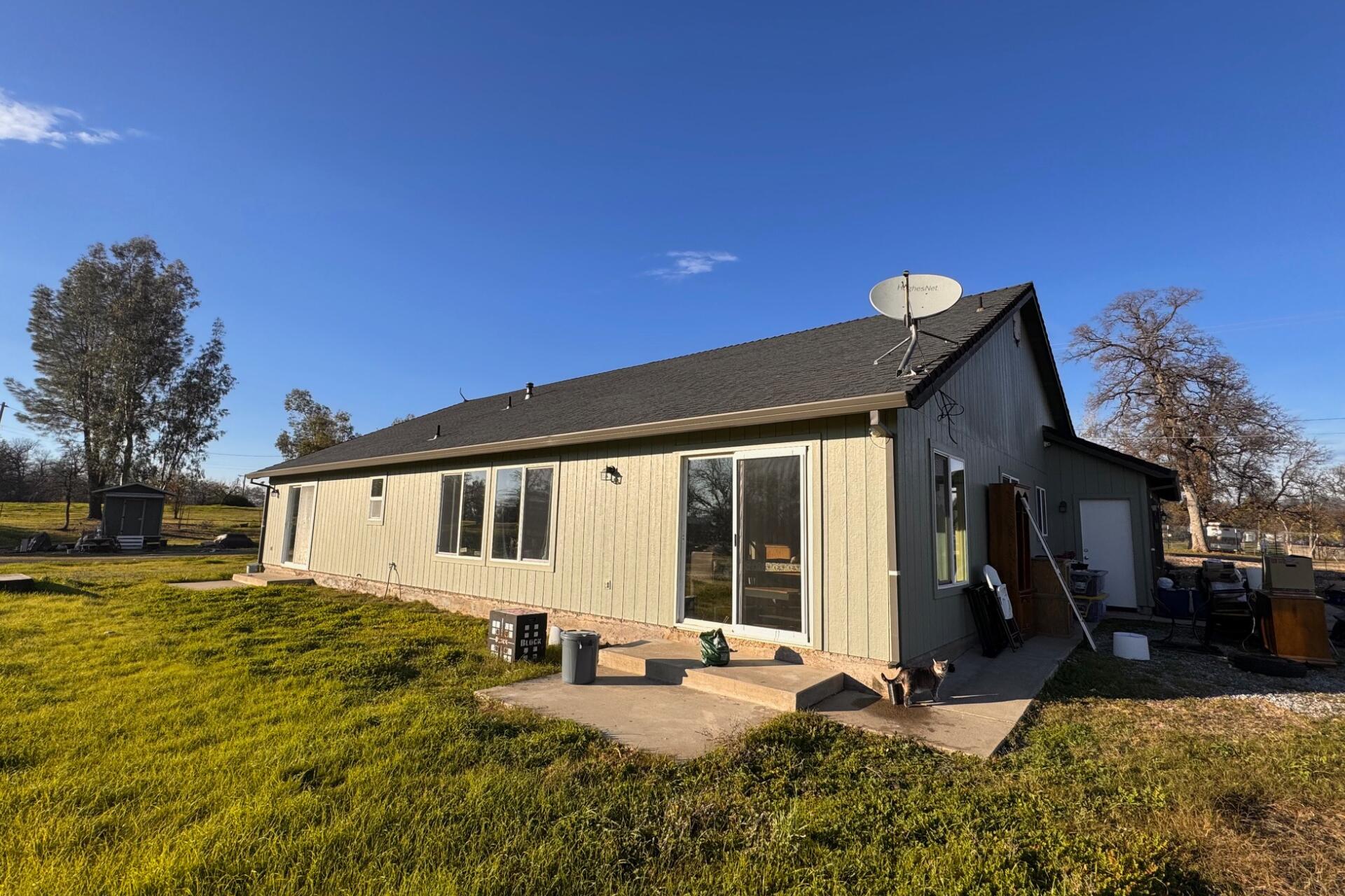 21193 El Toro Lane Redding, CA 96003 - Photo 8 of 13 a view of a house with backyard porch and sitting area