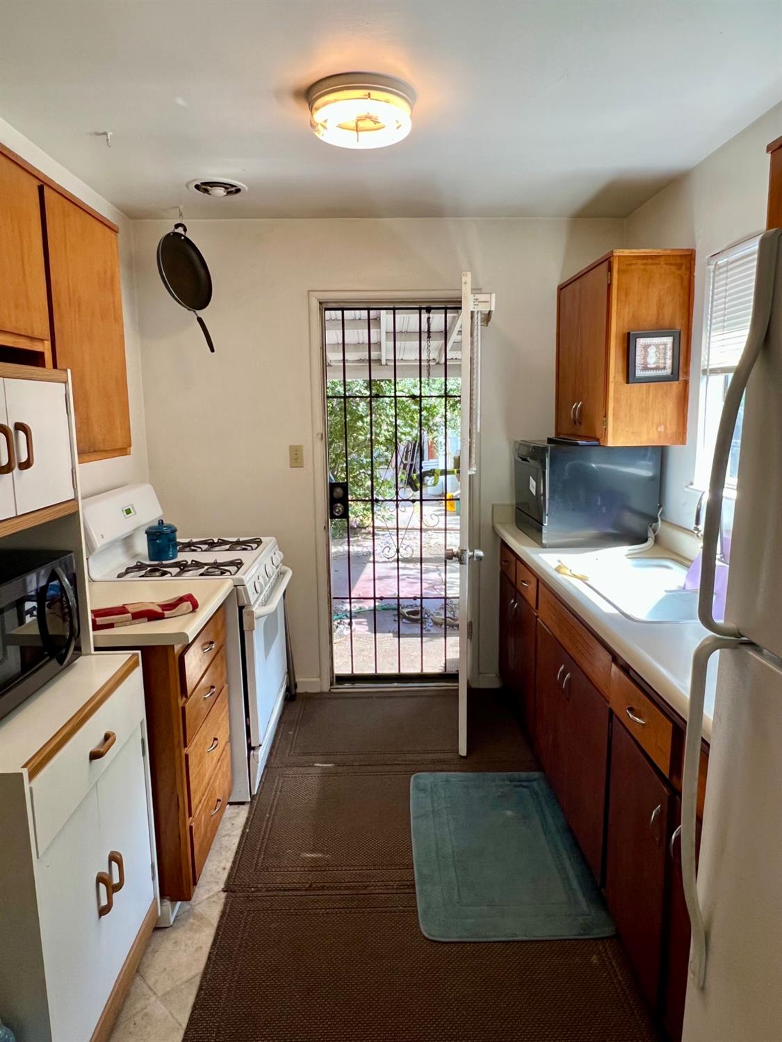 2101 Parr Avenue Modesto, CA 95358 - Photo 13 of 20 a kitchen with a sink stove and refrigerator