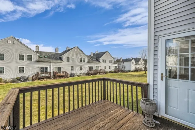 a view of a big room with a big yard and large trees
