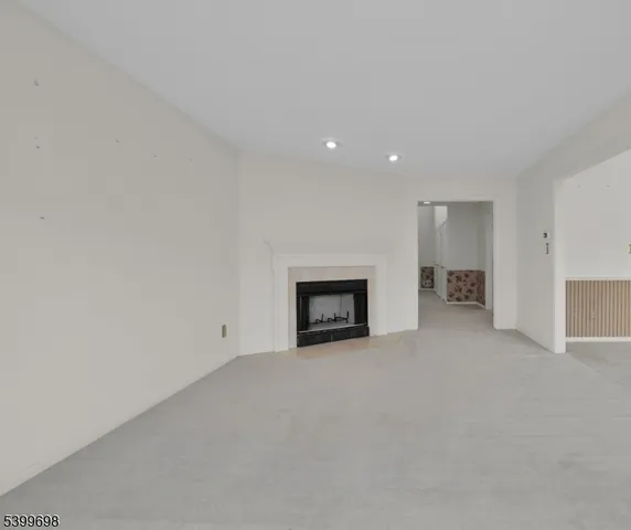a view of an empty room with a fireplace