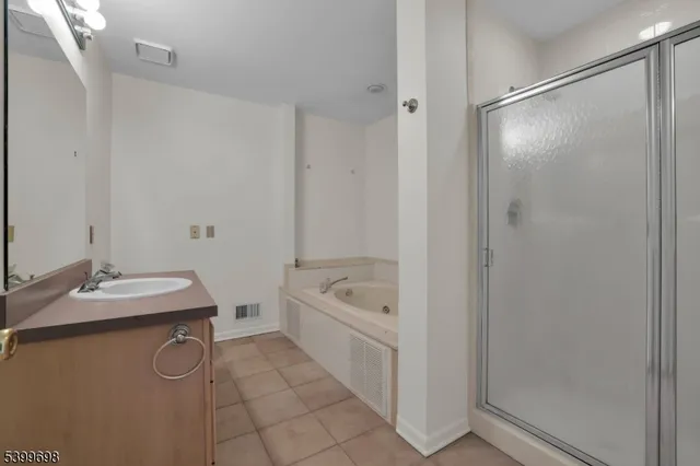 a bathroom with a granite countertop sink a toilet and shower