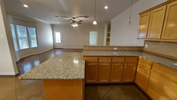 a bathroom with a granite countertop sink a mirror and a shower