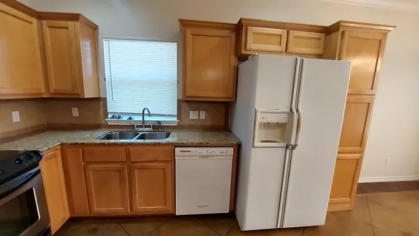 a kitchen with stainless steel appliances a refrigerator and a stove