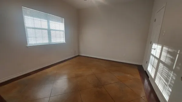 a view of an empty room with a window