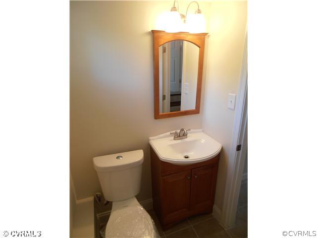 6316 Barrister Road Chesterfield, VA 23832 - Photo 11 of 12 a bathroom with a toilet sink and mirror