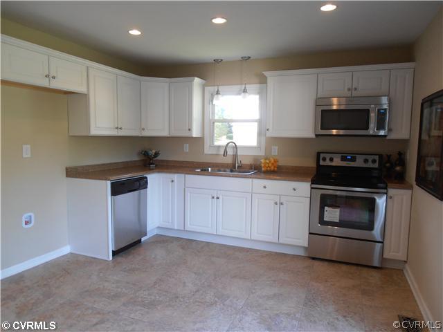 6316 Barrister Road Chesterfield, VA 23832 - Photo 4 of 12 a kitchen with granite countertop white cabinets stainless steel appliances and a sink