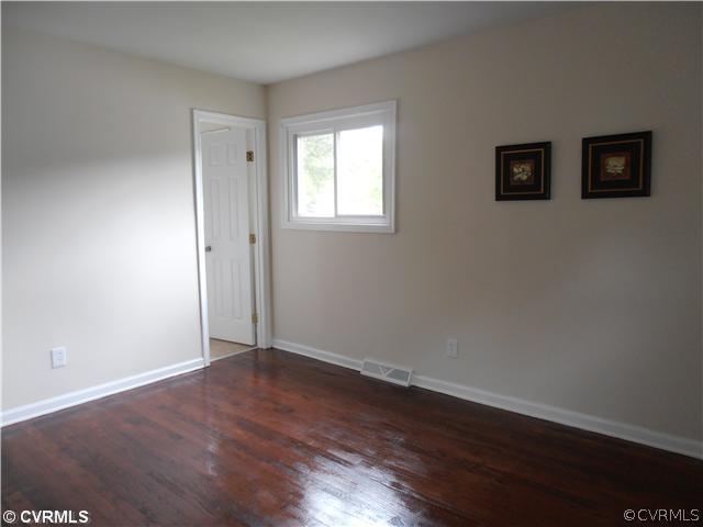 6316 Barrister Road Chesterfield, VA 23832 - Photo 6 of 12 a view of an empty room with wooden floor and a window