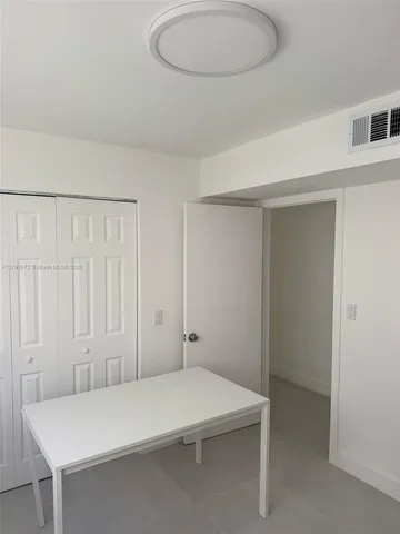 a room with a table and chairs