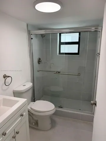 a bathroom with a toilet sink and shower