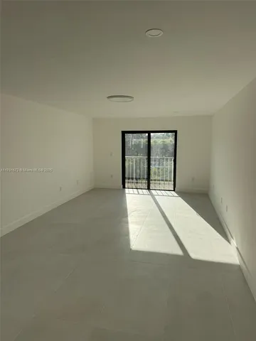 an empty room with large windows