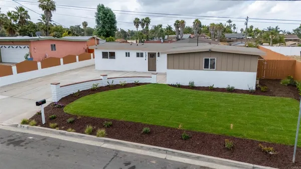 a view of a house with a backyard