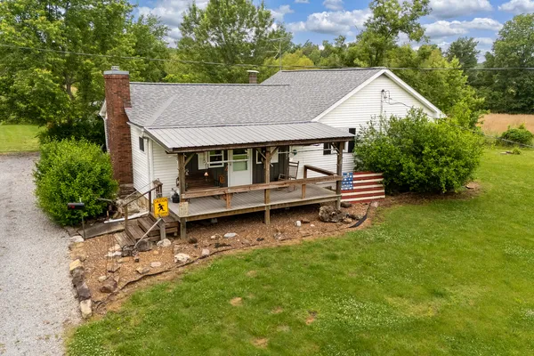 an aerial view of a house with a yard table and chairs